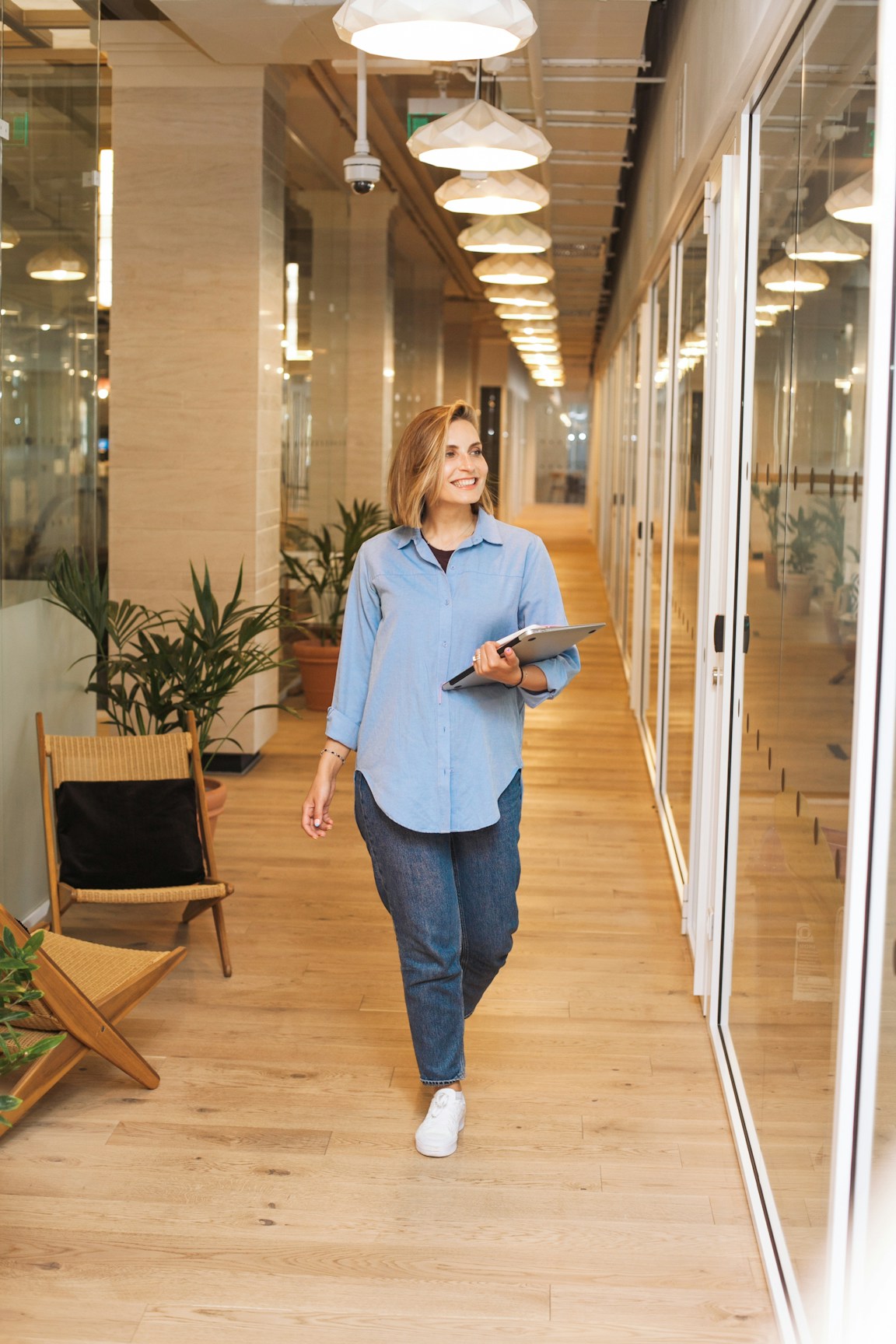 Sarah, an independent charter broker in her late thirties, working at a dual-monitor desk