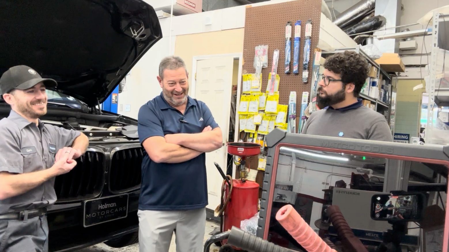 A technician and the research team in conversation on the shop floor during a first-round interview