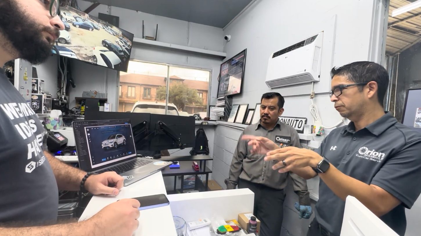 A technician using the ZF Diagnostic System prototype on a device during an on-site usability session in a repair shop