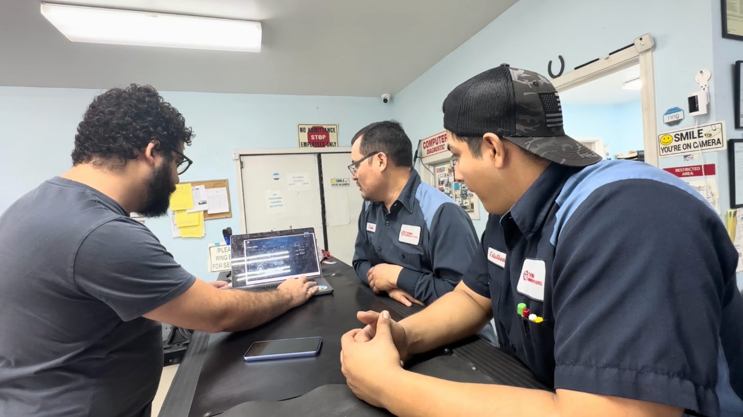 A moderated usability session with a mechanic reviewing the prototype while the research team observes