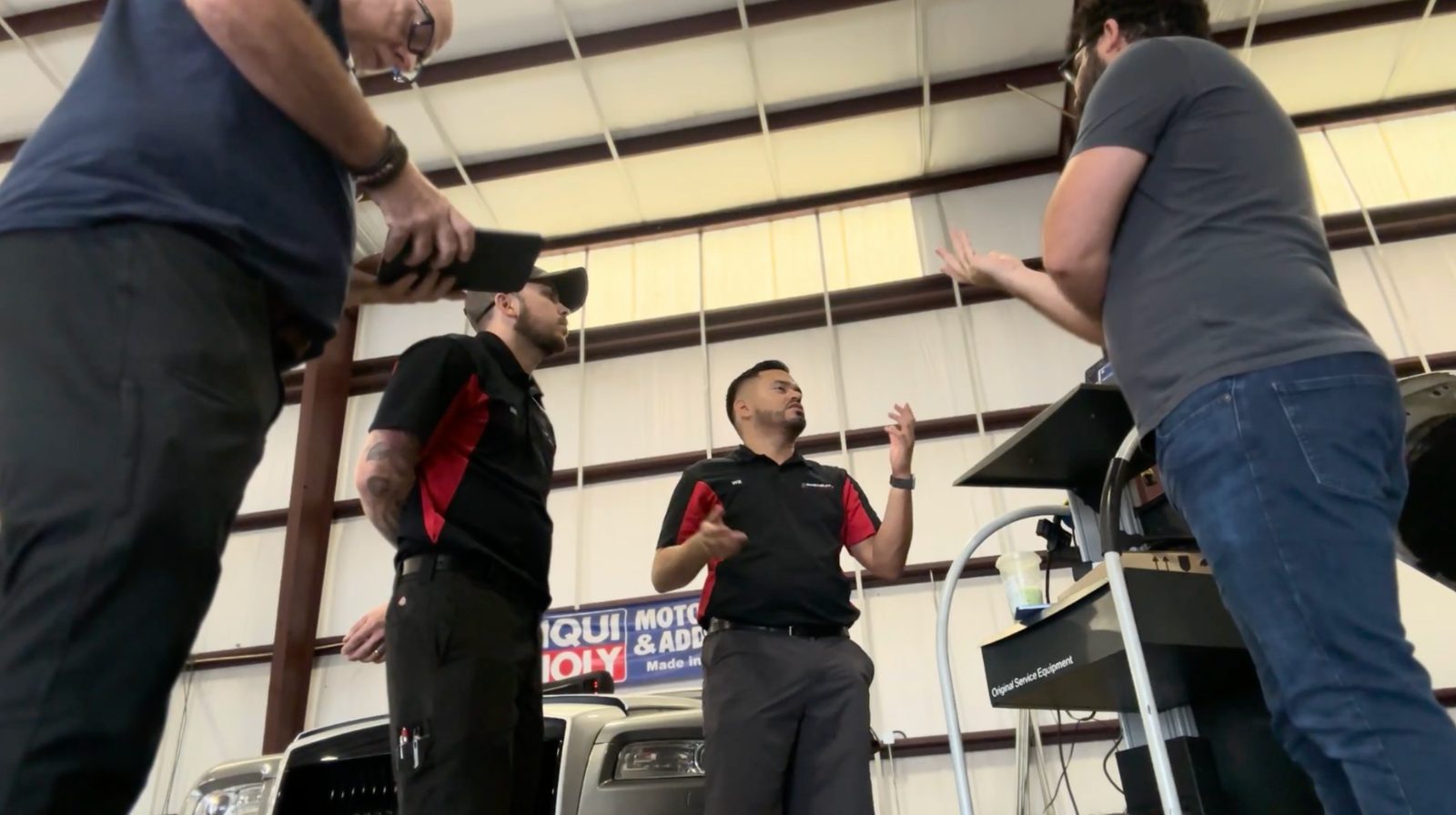 Another on-site testing session with technicians reacting to the diagnostic prototype in the shop