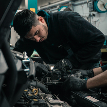 Tyler, a line technician in his late twenties, at his shop bay